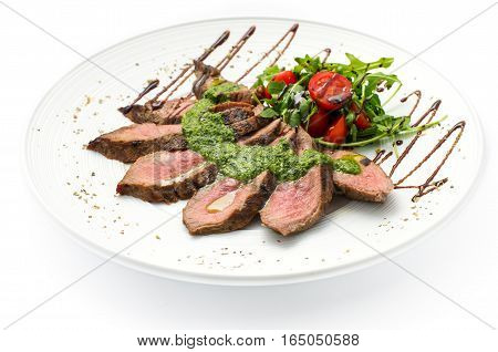 sliced veal steak medium rare with sauce on a white plate white background