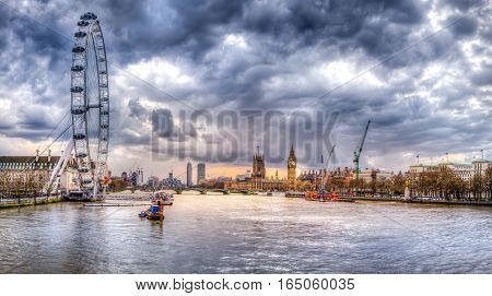 London skyline and Thames river view from embankment bridge