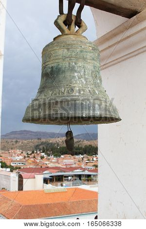 Sucre Bolivia - December 7 2016: Bronze church bell in bell tower of La Merced Church with view of Sucre Bolivia on December 7 2016