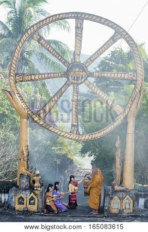 monk in buddhism temple thailandBeautiful women salute monks in buddhism temple.