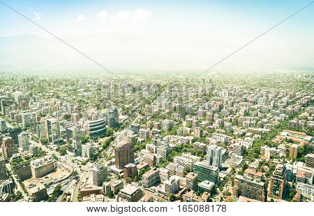 Aerial drone view of skyscrapers in downtown district of Santiago de Chile - Modern buildings and skyline in chilean biggest city with green areas and streets intersections - Warm bright color tones
