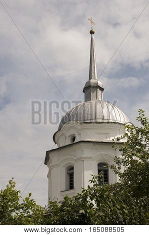 Christian orthodox white church with silver domes and gold crosses