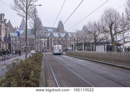 Amsterdam Netherlands- December 302016: In the streets of the ancient city tourists move and transport.Residents ride bikes
