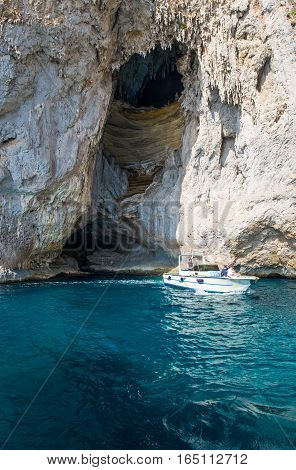 Capri Italy - October 20 2008: A boat with tourists leaving the Arco Naturale sea cave on the south coast