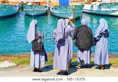 Capri Italy - April 22 2007: A group of nuns waithing in the Marina Grande harbor