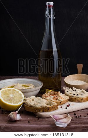 The homemade hummus and ingredients in rustic style.