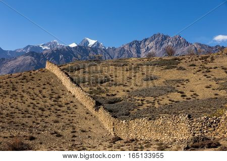 Fence made of stone in the mountains Himalayas Nepal.