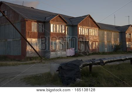 Misery and poor two-storeyed building in the evenong light