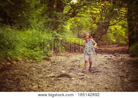 Cute running girl in autumn forest. Bulgaria