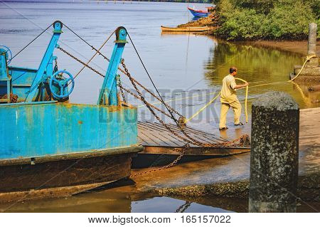 Goa, India - November 13, 2012: Ferry was moored to the shore. Ferry arriving to Chorao island Goa India. Ferries is only means of transport across many rivers of India as there is no bridge