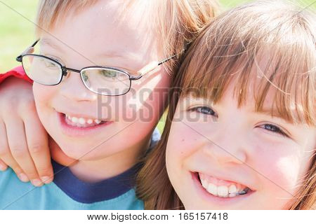Cute Little Boy With Downs-Syndrome With Big Sister