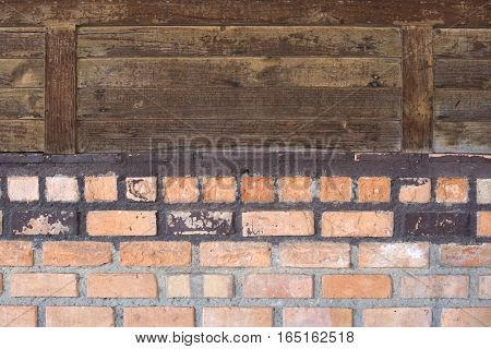 The old wall lower part of brick and the upper wood sheet.
