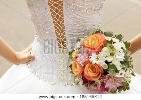 white lace corset wedding dress of the bride and the bridal bouquet