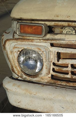 Picture of an old pick up truck's front head light.