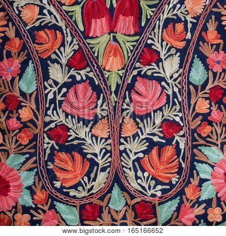Detail handmade pashmina shawl with delicate embroidery at outdoor crafts market in Kathmandu Nepal. Asian hand made souvenirs made with local craftsman and being sold at the market