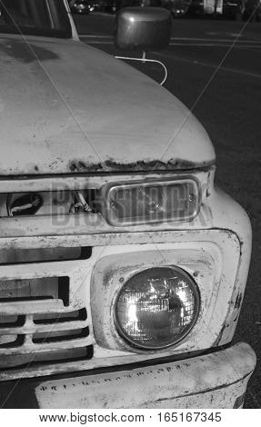 Vintage pick up truck in black and white showing it's rust and it's age.