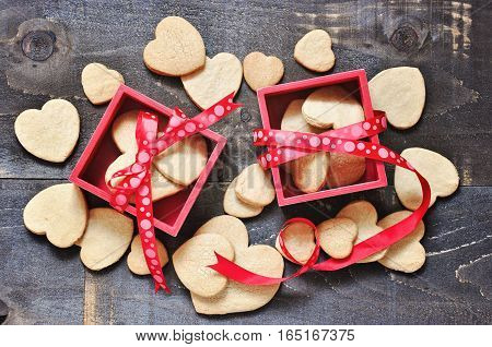 Shortbread cookies in the shape of hearts on wooden background St. Valentine