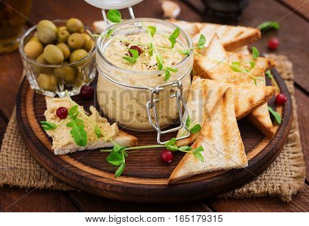 Pate Chicken - Rillette, Toast, Olives And Herbs On A Wooden Board