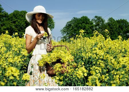 Young attractive woman relaxing in the rape field
