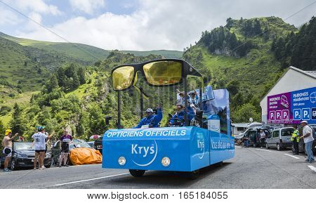 Col du Tourmalet France - July 242014: Krys caravan during the passing of the Publicity Caravan on the road to Col de Tourmalet in the stage 18 of Le Tour de France 2014.Before the appearance of the cyclists there is a caravan of advertising cars of the a