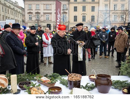 CRACOW POLAND - DECEMBER 18 2016: Cardinal Stanislaw Dziwisz during Christmas Eve for poor and homeless on the Central Market in Cracow.