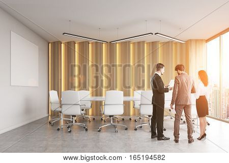 Rear view of a group of people discussing business stuff in a modern office conference room. White poster on a wall panoramic windows. 3d rendering. Mock up. Toned image