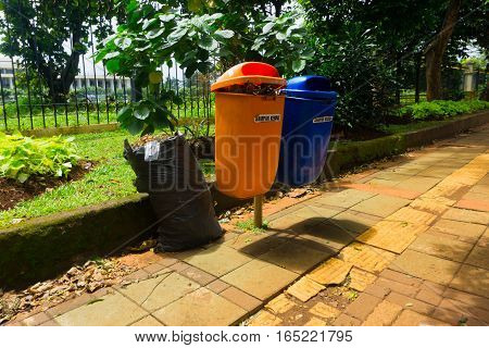 orange and blue trash bin photo taken in Jakarta Indonesia java