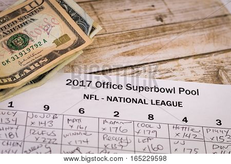 2017 Office Superbowl Pool with money on a wooden table
