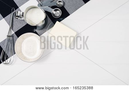 Baking a cake or pizza ingredients background. Top view photograph with kitchen utensils on vintage, natural, white, wooden background.