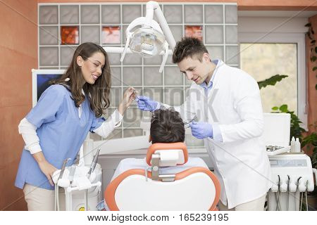 Young Man Having Dental Chekup At Dentist Office
