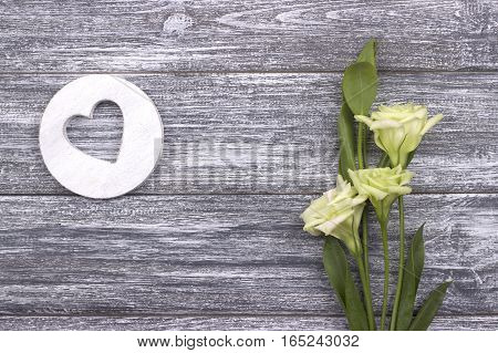Decorative white wooden heart on gray wooden background flowers with copy space . Valentines day card concept. Love. Wedding