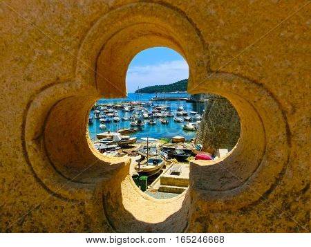 View through the fortress and marina in the old town of Dubrovnik, Croatia. Dubrovnik is a UNESCO World Heritage site