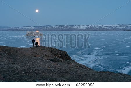 The photographer takes a photo of the moon on a medium format camera.