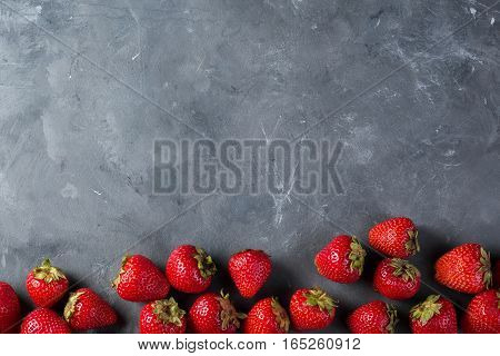 Strawberry. Fresh strawberry on dark background . Red strawberry. Loosely laid strawberries in different positions. Copyspace.
