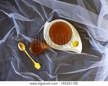 Cup of tea with honey on the table