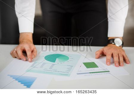 Business person analyzing financial statistics displayed on the tablet
