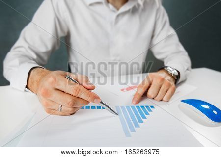 Business person analyzing financial statistics displayed on the tablet