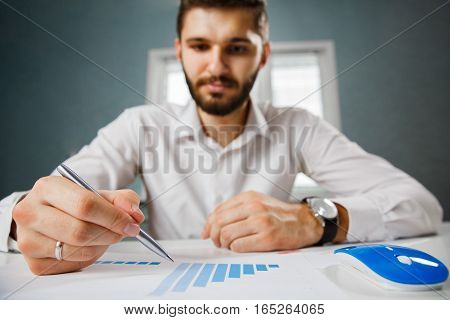 Business person analyzing financial statistics displayed on the tablet