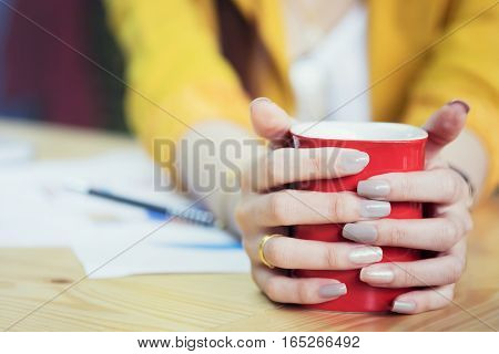 Businesswoman Holding Red Cup Of Coffee On Coffeebreak