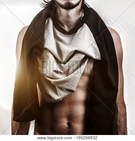 Muscular male body on white bacjground. Fashion