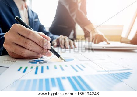 Team work process. young business managers crew working with new startup project. labtop on wood table typing keyboard texting message analyze graph plans.