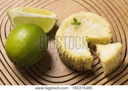 lime tart and sweet with lemon on wooden background