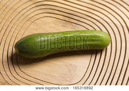 fresh cucumber with wooden background, close-up image