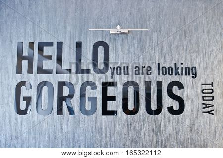 Shiny Sign Hello You Are Looking Gorgeous, Mounted On Glossy Marble Wall.