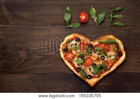 Heart Shaped Pizza For Valentines Day On Dark Rustic Wooden Background With Text Love.