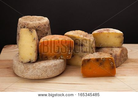 Different kinds of cheese and on a wooden table