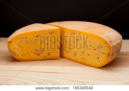 Sliced piece of cheese on a wooden table