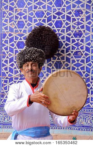 KHIVA, UZBEKISTAN - MAY 4, 2011: Traditional Uzbek musician performing at Tosh Hovli palace