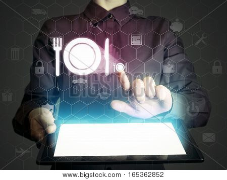 Image of a girl with tablet in her hands and food restaurant icon. She looking menus ordering food delivery rate restaurant with using online services.