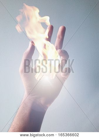 Cropped hand with a fire ball. Magical hands